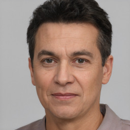 Joyful white adult male with short  black hair and brown eyes