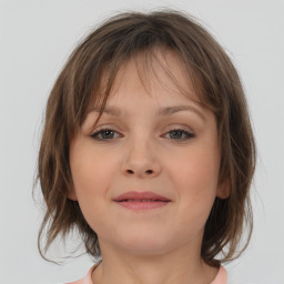 Joyful white child female with medium  brown hair and brown eyes