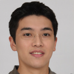 Joyful asian young-adult male with short  black hair and brown eyes