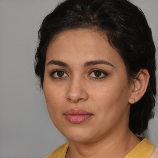 Joyful latino young-adult female with medium  brown hair and brown eyes