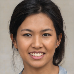 Joyful asian young-adult female with medium  brown hair and brown eyes