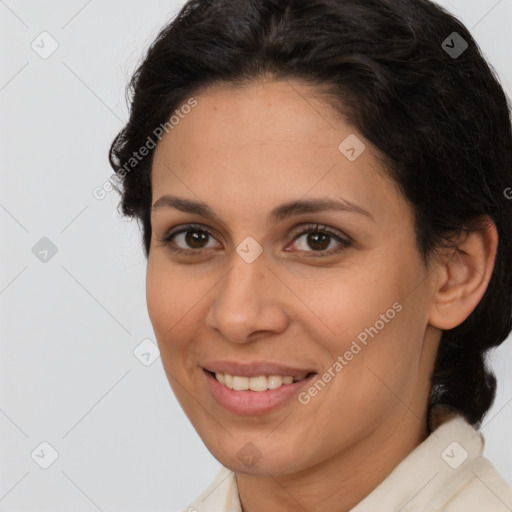 Joyful latino young-adult female with medium  brown hair and brown eyes