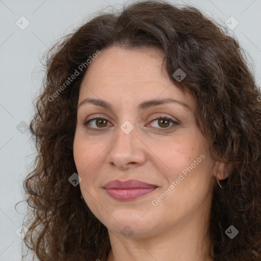 Joyful white adult female with long  brown hair and brown eyes