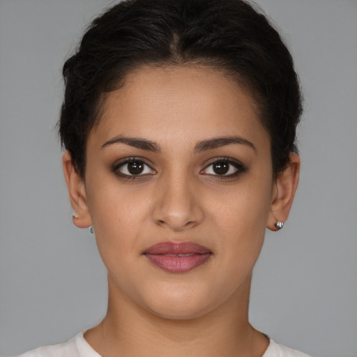 Joyful latino young-adult female with short  brown hair and brown eyes