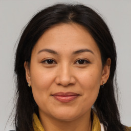 Joyful asian adult female with medium  brown hair and brown eyes