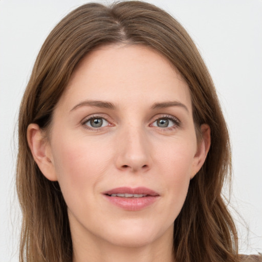 Joyful white young-adult female with long  brown hair and grey eyes