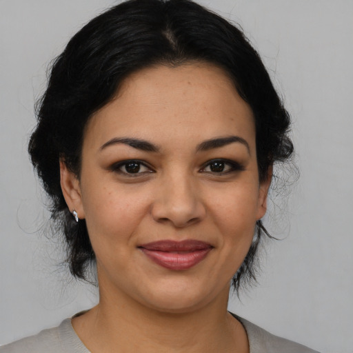 Joyful latino young-adult female with medium  black hair and brown eyes