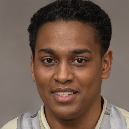 Joyful black young-adult male with short  black hair and brown eyes