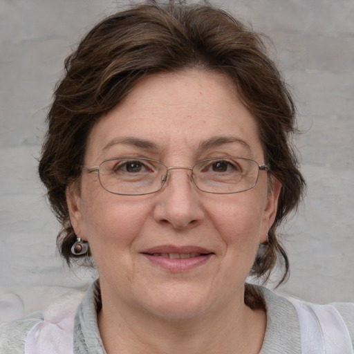 Joyful white adult female with medium  brown hair and blue eyes