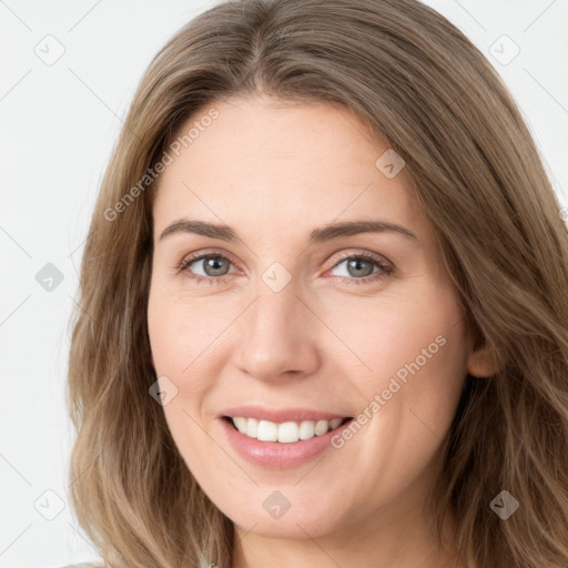 Joyful white young-adult female with long  brown hair and green eyes