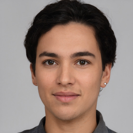 Joyful white young-adult male with short  black hair and brown eyes