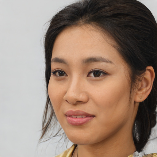 Joyful asian young-adult female with medium  brown hair and brown eyes