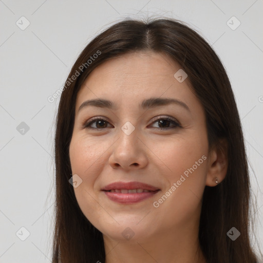 Joyful white young-adult female with long  brown hair and brown eyes