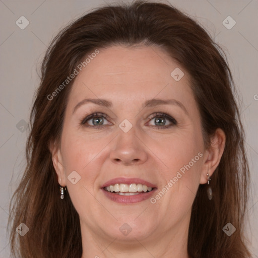 Joyful white adult female with long  brown hair and brown eyes