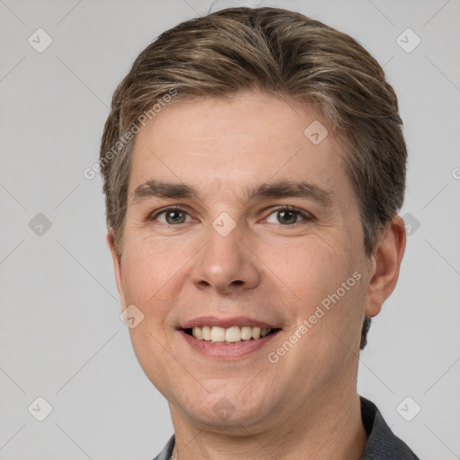 Joyful white adult male with short  brown hair and brown eyes