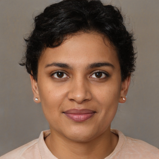 Joyful latino young-adult female with short  brown hair and brown eyes