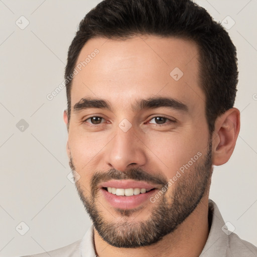 Joyful white young-adult male with short  brown hair and brown eyes