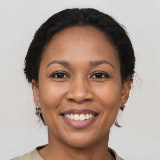 Joyful latino adult female with medium  brown hair and brown eyes