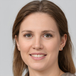 Joyful white young-adult female with medium  brown hair and grey eyes