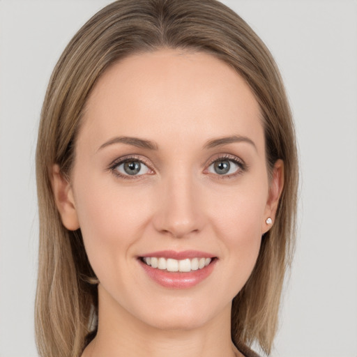 Joyful white young-adult female with long  brown hair and grey eyes