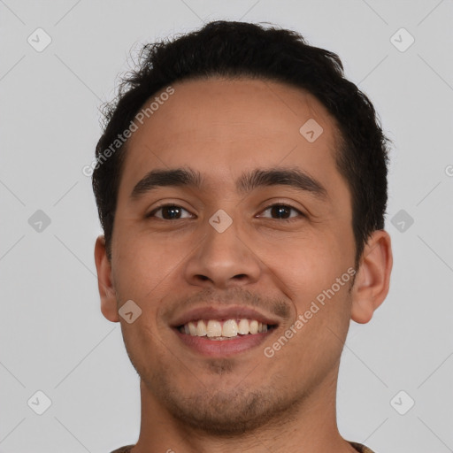 Joyful latino young-adult male with short  brown hair and brown eyes