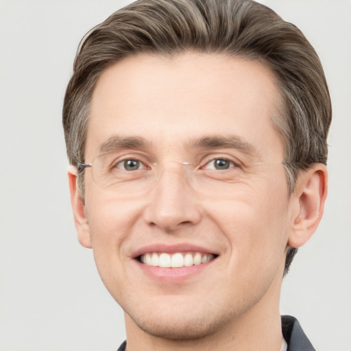 Joyful white adult male with short  brown hair and grey eyes