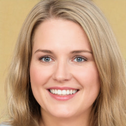 Joyful white young-adult female with long  brown hair and green eyes