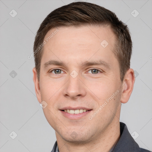 Joyful white young-adult male with short  brown hair and grey eyes