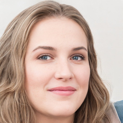 Joyful white young-adult female with long  brown hair and blue eyes