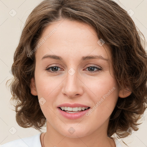 Joyful white young-adult female with medium  brown hair and green eyes