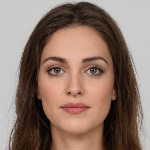 Neutral white young-adult female with long  brown hair and brown eyes