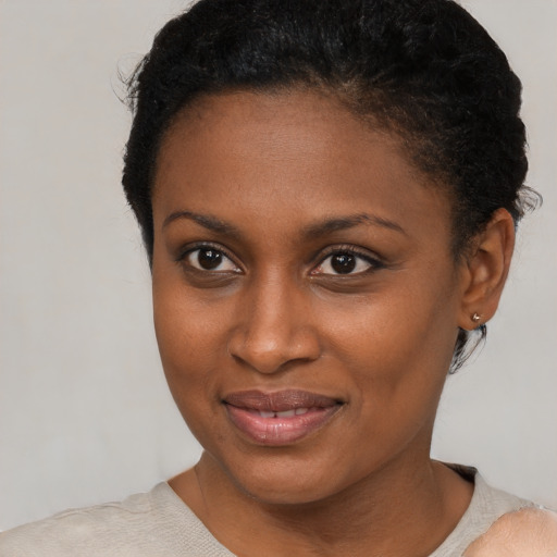 Joyful black young-adult female with short  brown hair and brown eyes