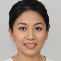 Joyful asian young-adult female with short  brown hair and brown eyes