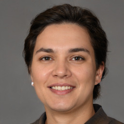 Joyful white adult female with medium  brown hair and brown eyes