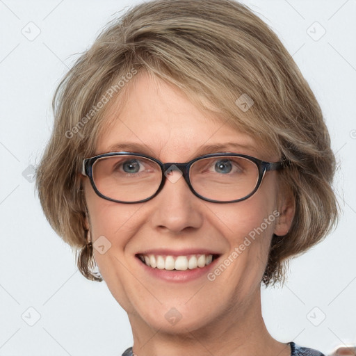 Joyful white adult female with medium  brown hair and blue eyes