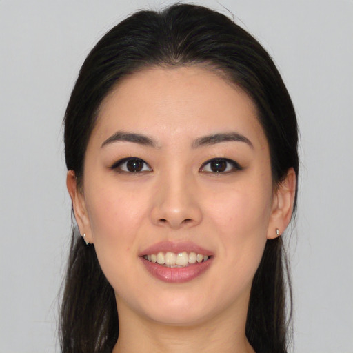 Joyful asian young-adult female with long  brown hair and brown eyes