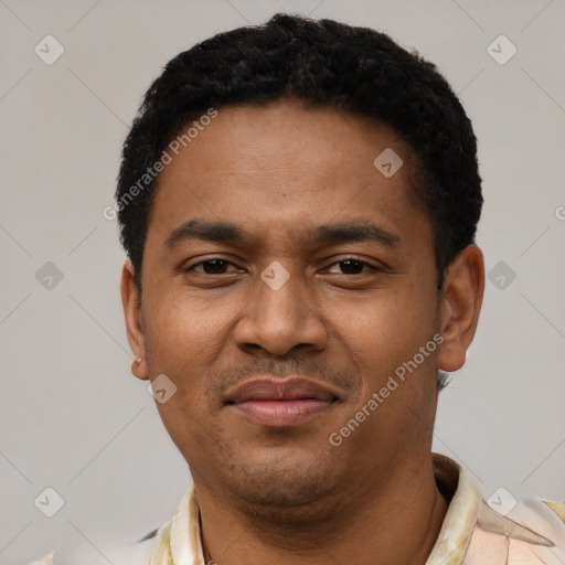 Joyful latino young-adult male with short  black hair and brown eyes