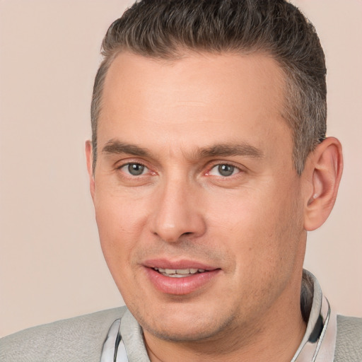 Joyful white adult male with short  brown hair and brown eyes