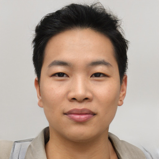 Joyful asian young-adult male with short  brown hair and brown eyes