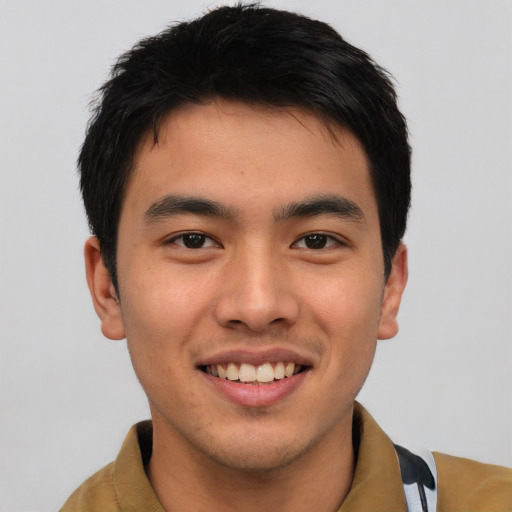 Joyful asian young-adult male with short  brown hair and brown eyes