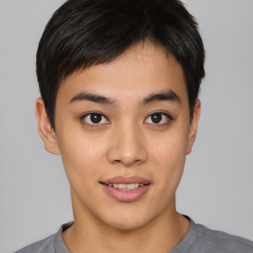 Joyful asian young-adult male with short  black hair and brown eyes