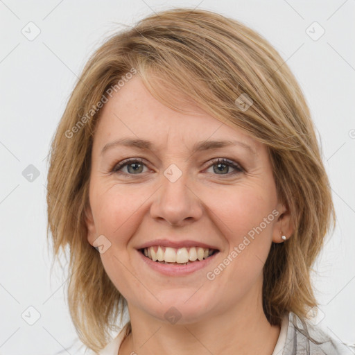 Joyful white young-adult female with medium  brown hair and blue eyes