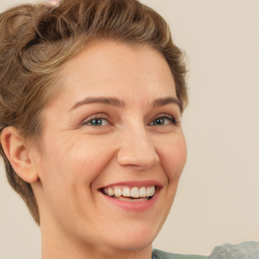 Joyful white young-adult female with short  brown hair and green eyes