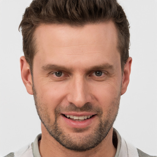 Joyful white adult male with short  brown hair and brown eyes