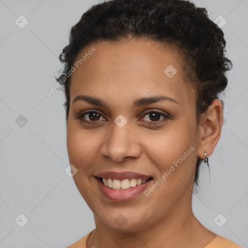 Joyful latino young-adult female with short  brown hair and brown eyes