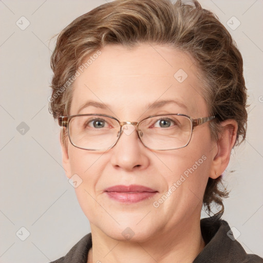 Joyful white adult female with medium  brown hair and blue eyes