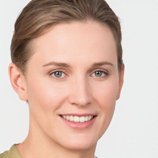 Joyful white young-adult female with short  brown hair and grey eyes