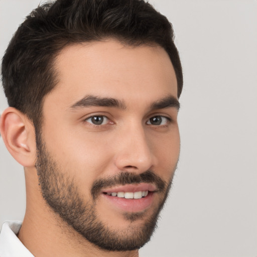 Joyful white young-adult male with short  brown hair and brown eyes