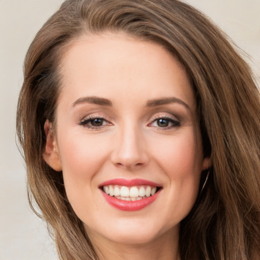 Joyful white young-adult female with long  brown hair and grey eyes