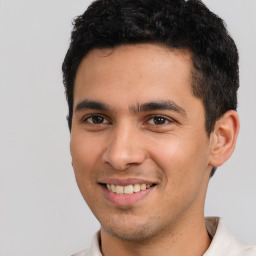 Joyful white young-adult male with short  black hair and brown eyes